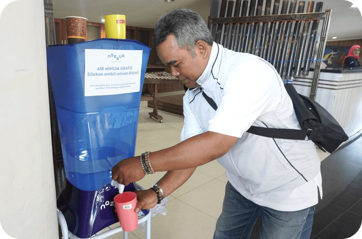 Taking drinking water from a Nazava Water Filter at the Indonesia National City Sanitation summit in Bandung organized by Akkopsi